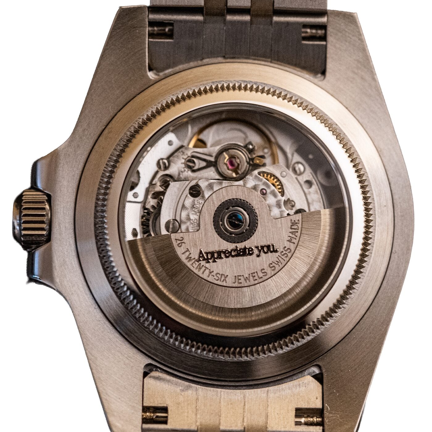 Exhibition caseback in full view, rotor engraved “Appreciate you.” beside “26 twenty-six jewels Swiss made”